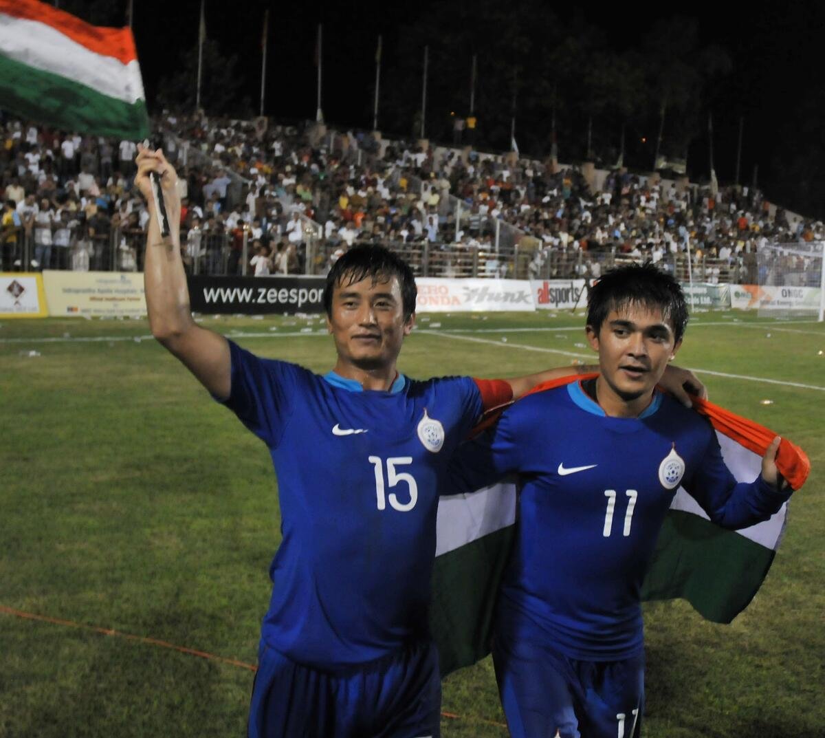 Chhetri (R) celebrates with Bhaichung Bhutia after winning the Nehru Cup in 2009. 